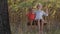 Cheerful siblings on swing enoying summer day