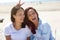 Cheerful sisters having fun at the beach