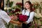 cheerful small business entrepreneur woman orangery owner give flowers to client