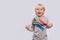 Cheerful smiling boy holding flag of South Africa on white background