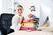 Cheerful smiling businesswoman laying on the stack of colorful folders