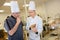 Cheerful smiling cooks working together at kitchen in take-away restaurant