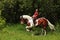 Cheerful smiling cowgirl ride bareback horse