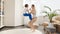 Cheerful smiling mother with her son doing sports and exercises in living room. Family healthcare, active lifestyle, parenting and