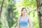 Cheerful sportswoman in the green park, Smile girl exercising outdoors, Healthy lifestyle concepts