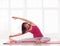 Cheerful sportswoman stretches in a half-bound ankle pose