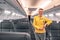 Cheerful stewardess standing in aircraft passenger salon