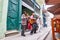 Cheerful street musicians playing on a street outdoors and people watching on a terrace in Cuba