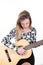 Cheerful stylish blonde woman playing learning guitar