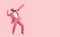 Cheerful successful man dancing funny making movements winner isolated on pink background.