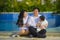 Cheerful and sweet wife and husband couple with mother holding baby girl and man playing with little daughter in Asian Chinese