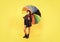 cheerful teen child hold colorful parasol. kid in hat with rainbow umbrella.