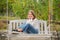 cheerful teen girl having free time outside on swing, relaxation