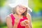 Cheerful teenage girl with dental braces glasses and ice cream. Portrait of a smiling pretty young girl in summer outfit with ice