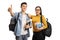 Cheerful teenage students with backpack and books making a thumb
