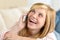 Cheerful teenage woman laughing calling on phone
