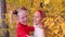 Cheerful teenager girls laughing and dancing together in autumn park