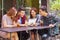 Cheerful teenagers using digital tablet in cafe