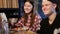 Cheerful teens enjoying meal sitting at cafe table