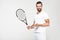 cheerful tennis player holding ball and racket,