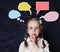 Cheerful thinking child girl with speech clouds bubbles on black