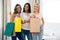 Cheerful three girls with many shopping bags