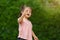 Cheerful toddler girl playing grass flower in field