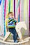 Cheerful toddler riding handmade wooden horse