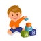 Cheerful toddler sitting collects a pyramid of colored cubes. Concept development and education of young children.