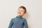 Cheerful toothless boy six years old in striped turtleneck on white background