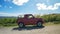 Cheerful tourist in a red jeep drives around Barbados and explores the island.