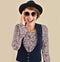 Cheerful trendy woman presenting retro sunglasses collection