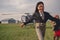 Cheerful tween girl running on background of helicopter on airfield