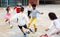 Cheerful tween schoolchildren playing with ball near school