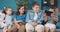 Cheerful two boys and two girls playing on tablet at home