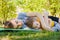 Cheerful two brothers sleep lie on the grass