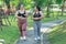 Cheerful two women overweight in sportswear have fun exercising in garden. Asian girls plus size wear sports uniform are friend