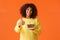 Cheerful upbeat african-american b-day girl having awesome birthday party, blow candle, holding plate with delicious