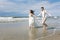 Cheerful wedding couple on the beach