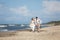Cheerful wedding couple on the beach