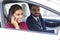 Cheerful wife speaking by phone while husband driving