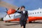 Cheerful woman airline worker standing outdoors at airport