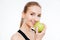 Cheerful woman athlete eating an apple