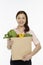 Cheerful woman with a bag of groceries