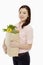 Cheerful woman with a bag of groceries