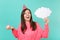Cheerful woman in birthday hat looking up, hold cake with candle, empty blank Say cloud speech bubble for promotional
