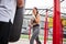 Cheerful woman boxing with male couch outdoors