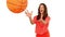 Cheerful woman catching a basketball on white background