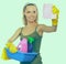 Cheerful woman is cleaning something with wisp and spray attentively.