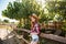 Cheerful woman cowgirl walking on farm